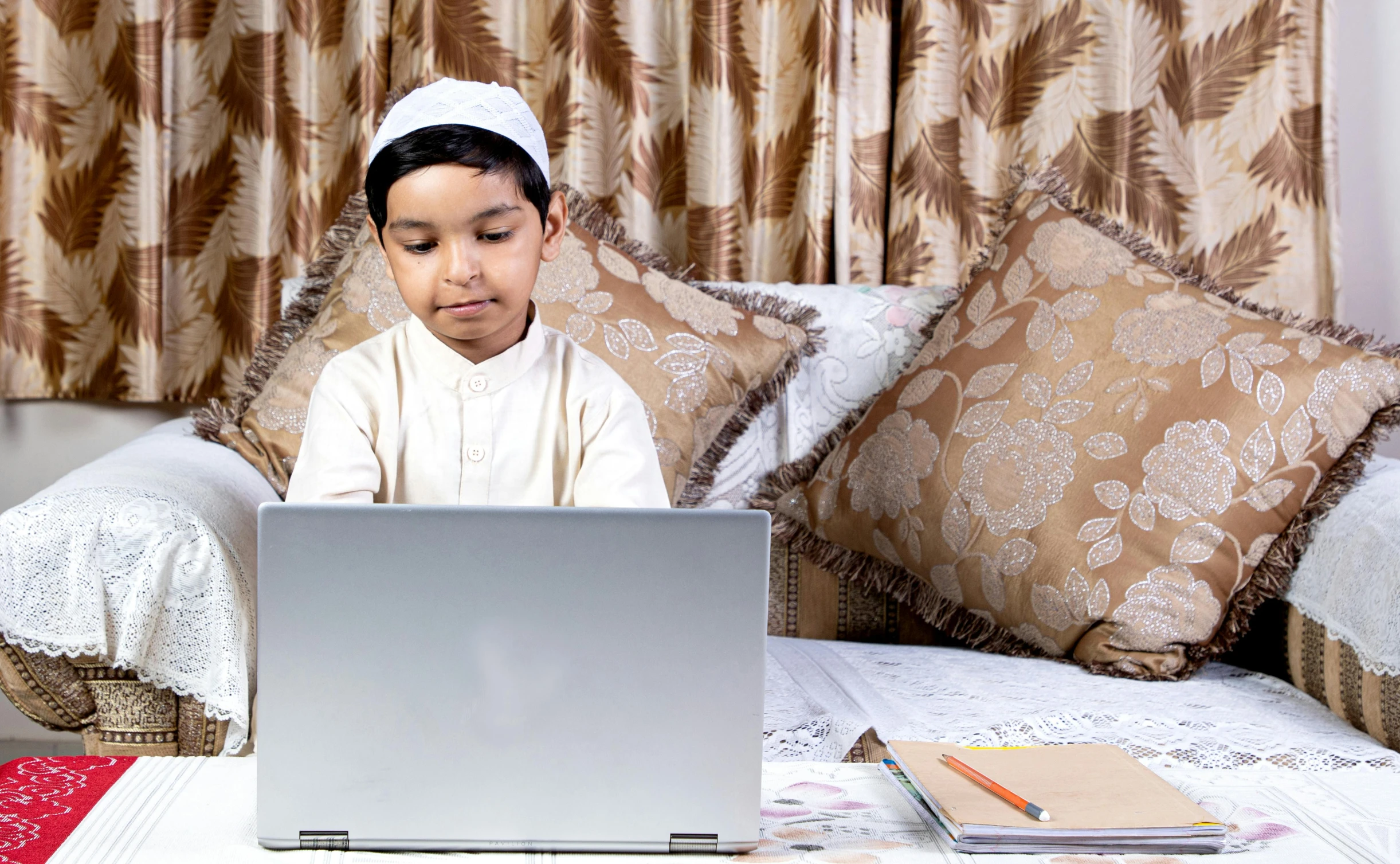 a young child sitting in front of a laptop