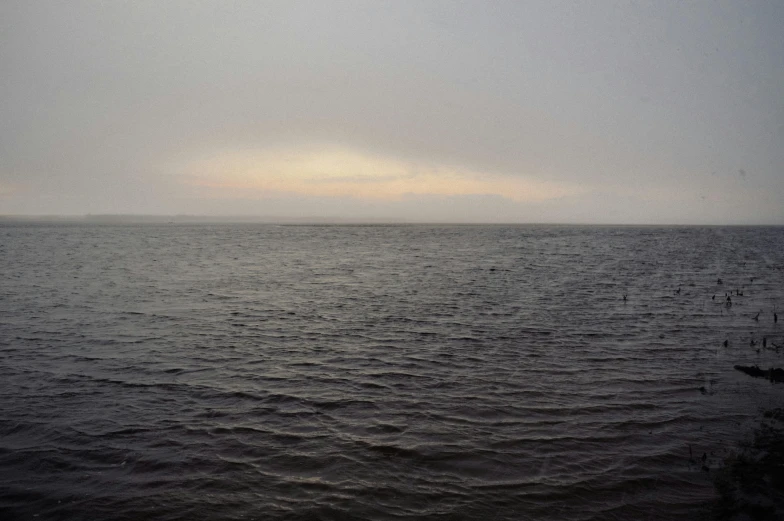 an image of a plane flying over the water