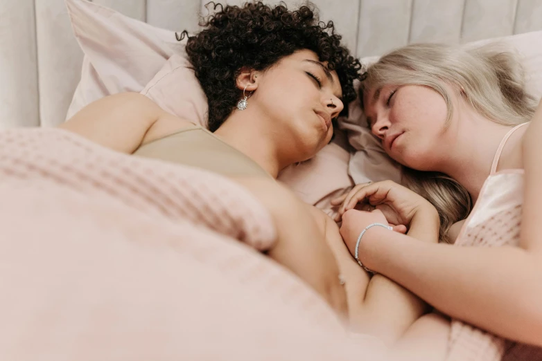there are two women sleeping next to each other