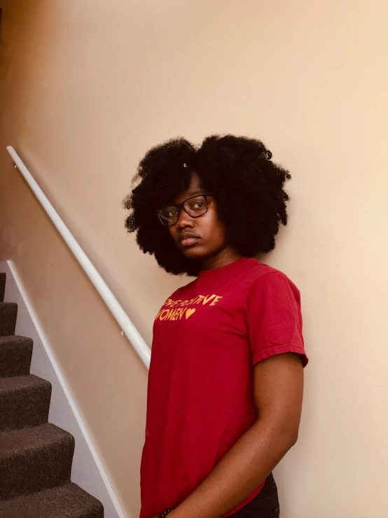 a person standing next to a hand rail in a room