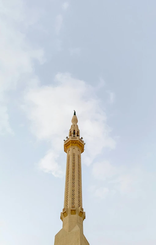 a stone tower with a bird on top and trees around