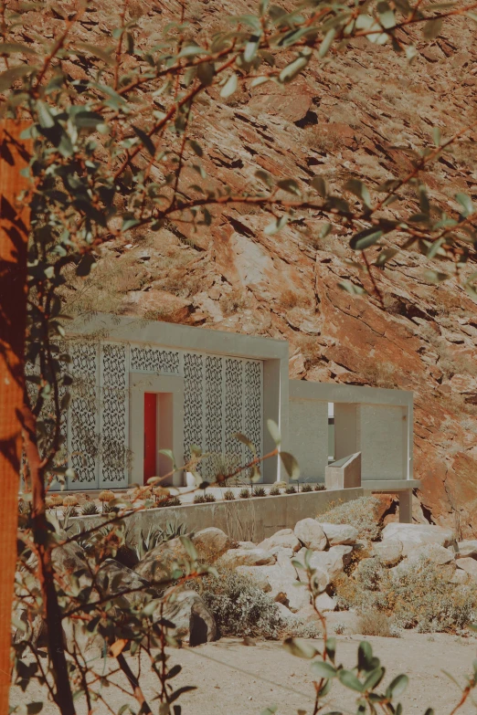 a building on a desert with some trees