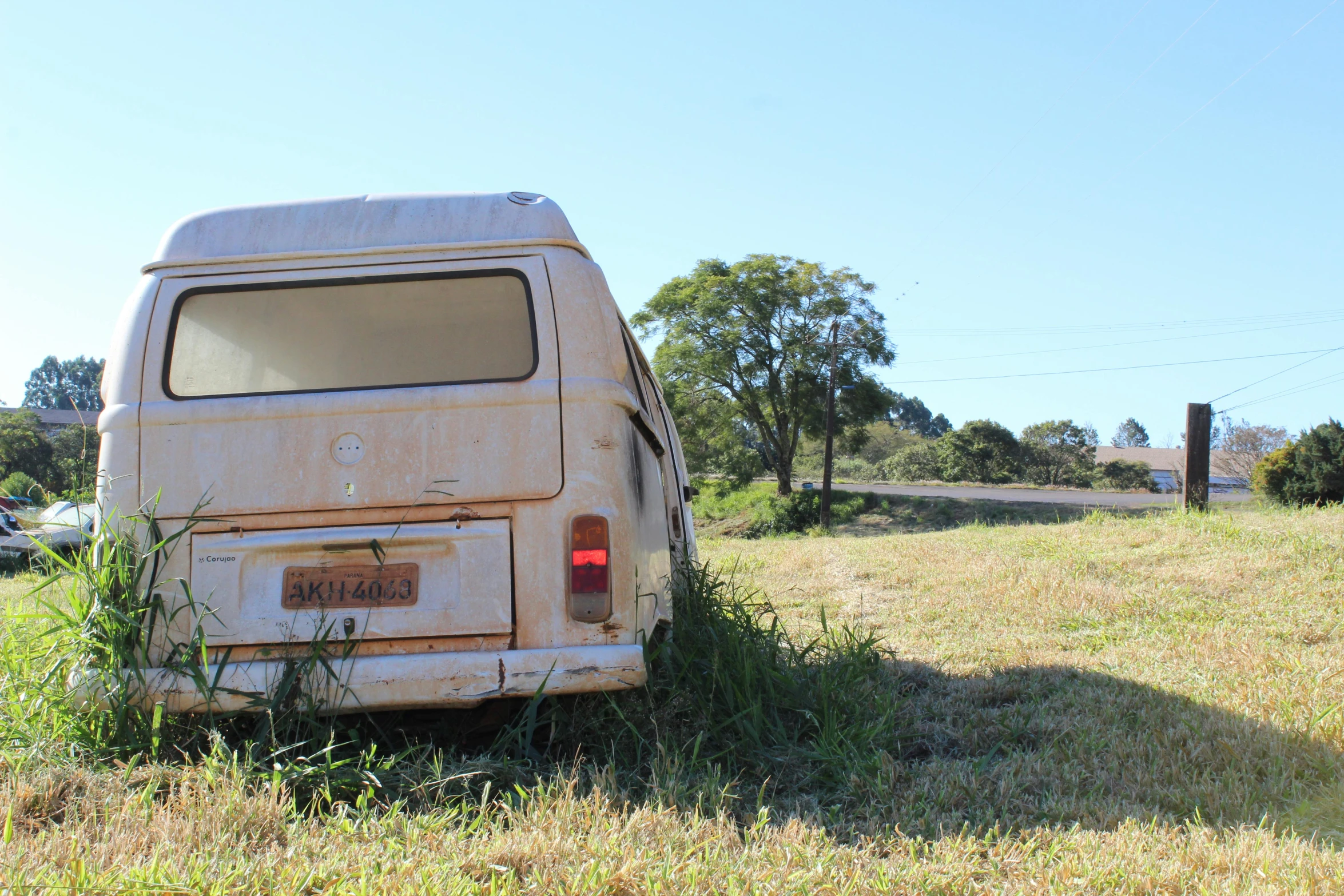 an old van in the middle of a grassy field