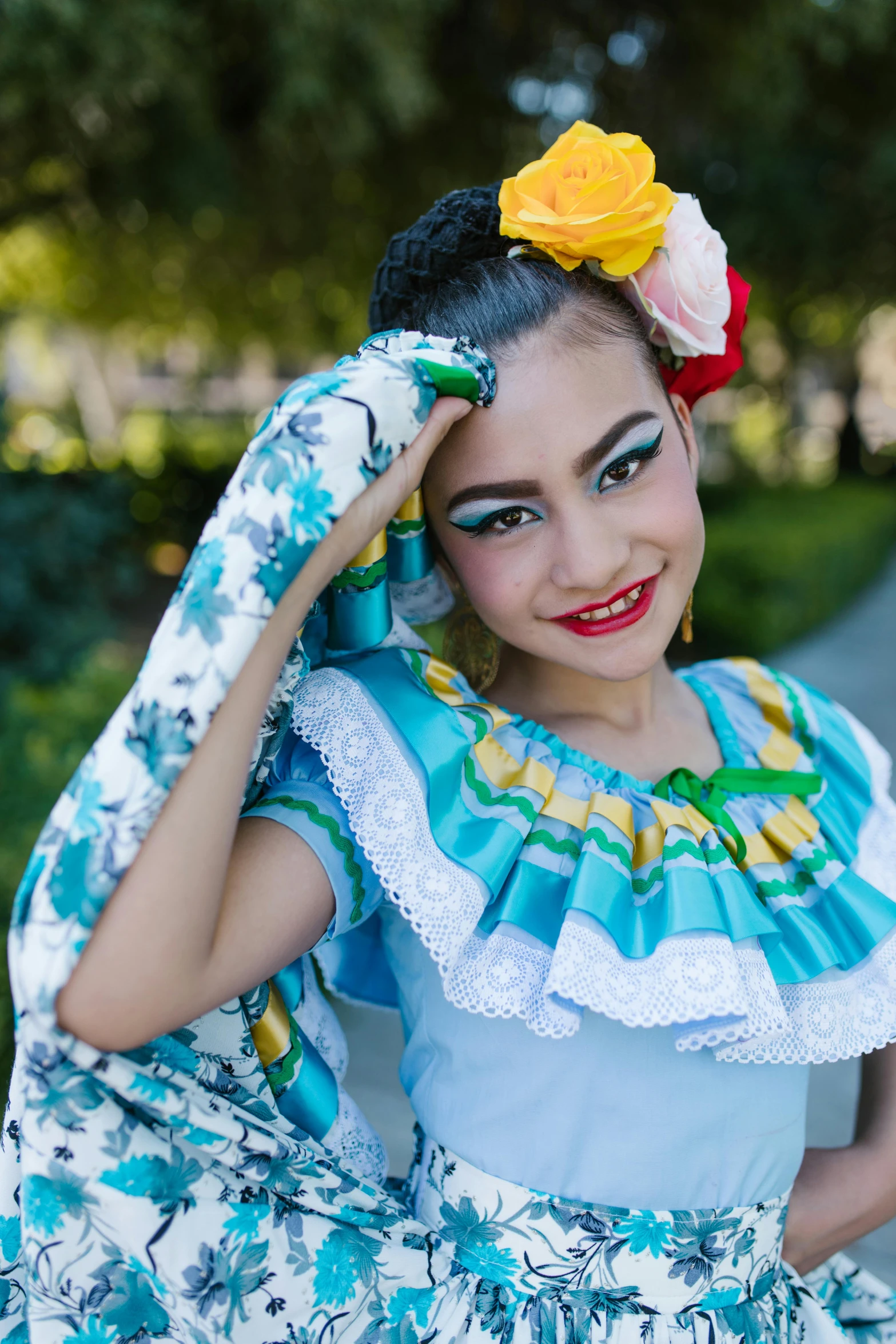 a smiling woman in colorful attire, with flowers in her hair