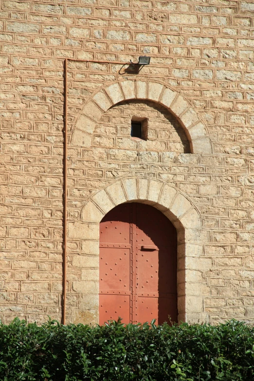 there are two brown door panels on the outside of a brick building