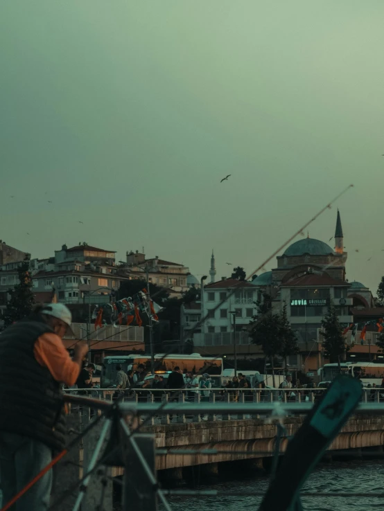 an image of people walking on the dock in the evening