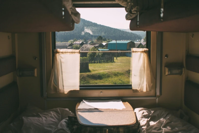 a bed room with a window looking at mountains