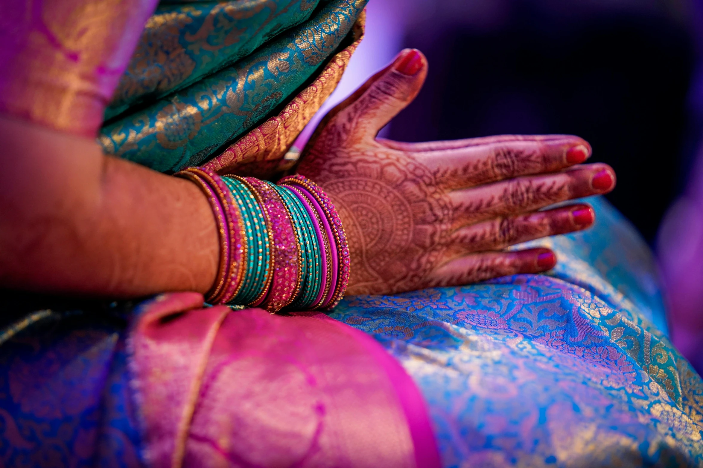 a woman in a colorful outfit and jewelry