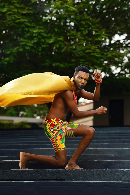 man in traditional african costume holding a banana