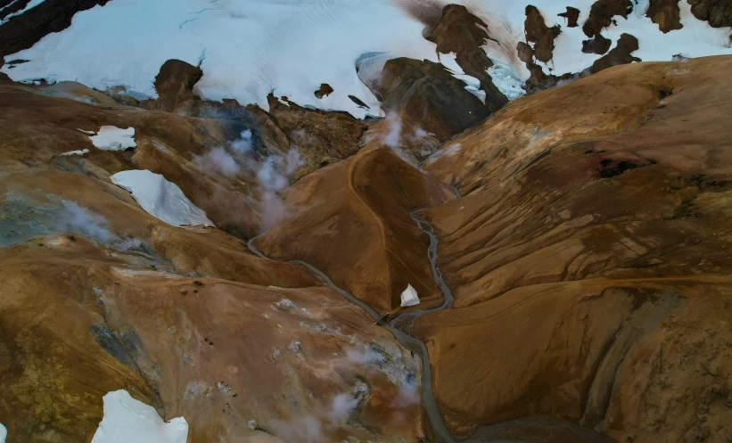 an aerial po of snow covered mountain sides