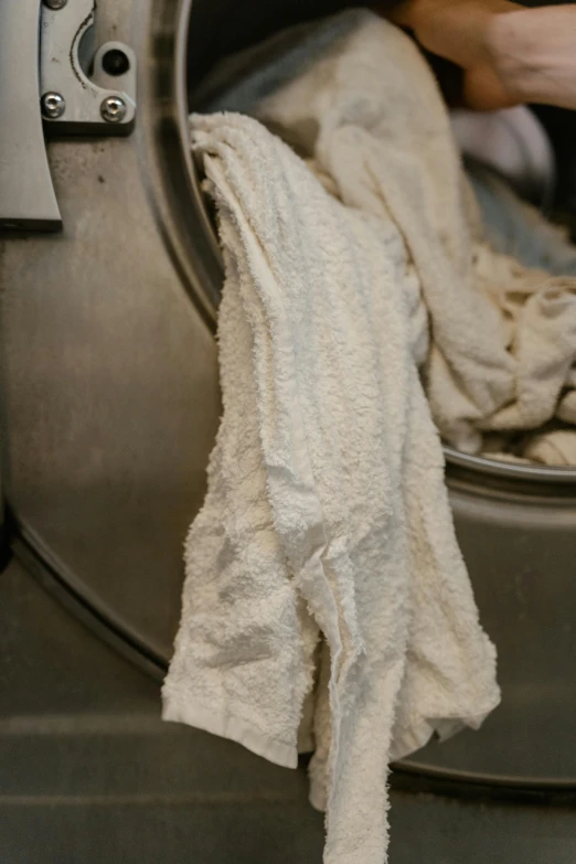 a person is holding onto the door of a dryer