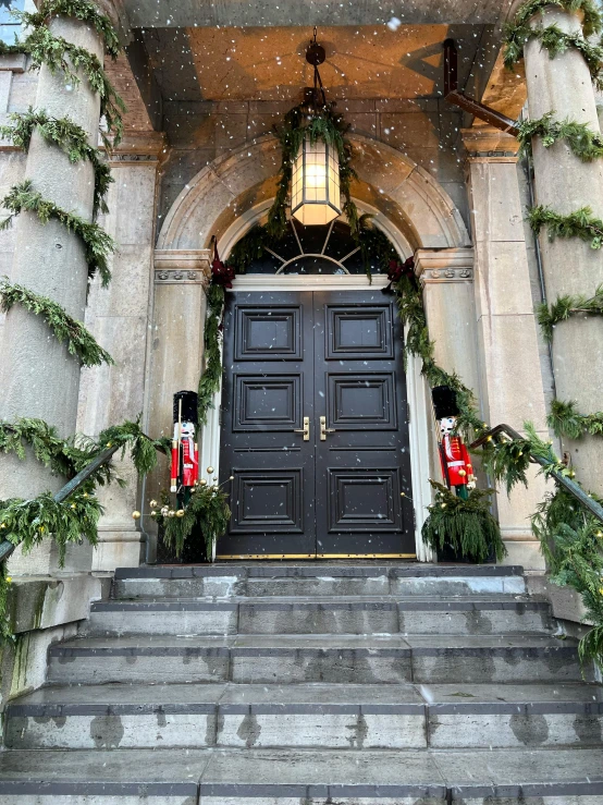 a large black door surrounded by columns