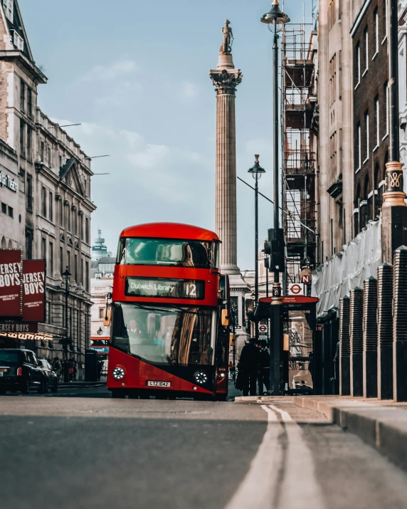 a double decker bus is going down the street