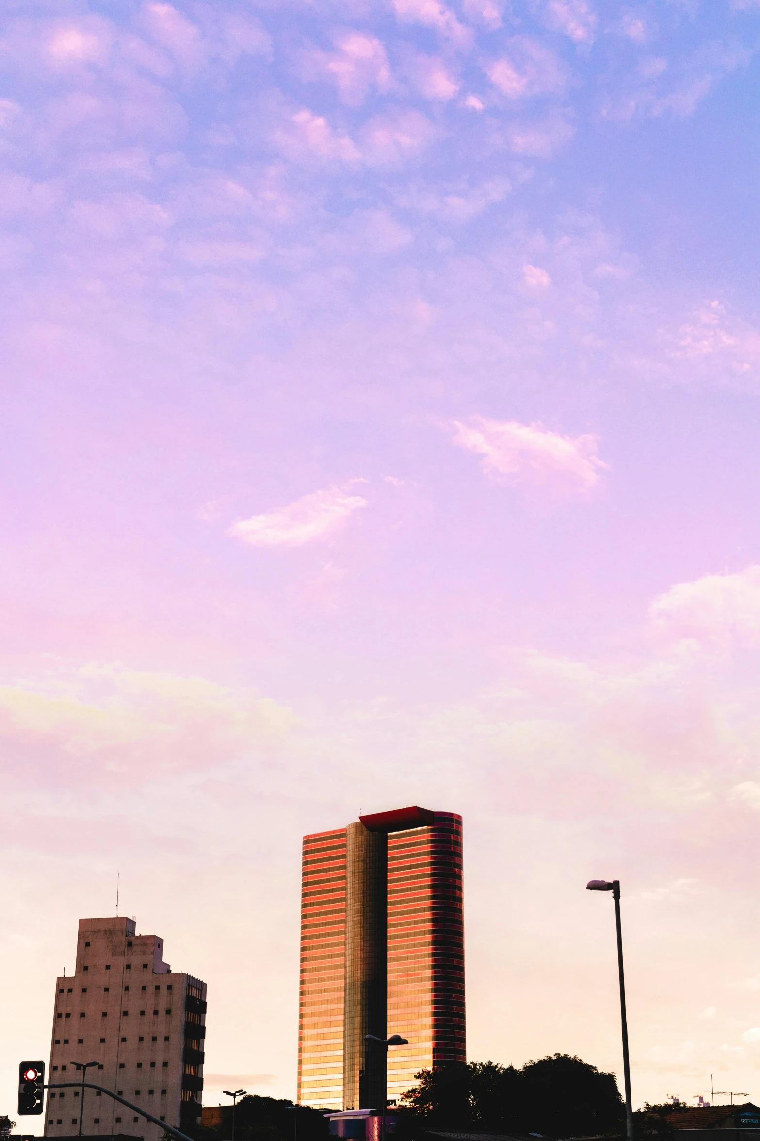 a view of a tall building and some light poles