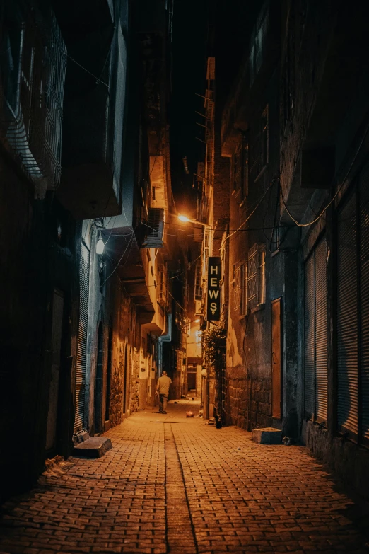 an alley way with brick roads and cobblestone pavement