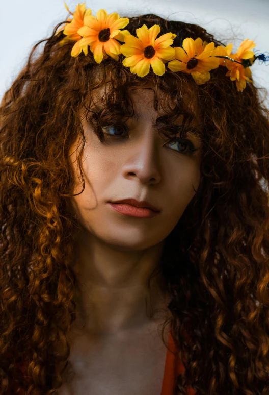 a woman is wearing a flower crown on her head