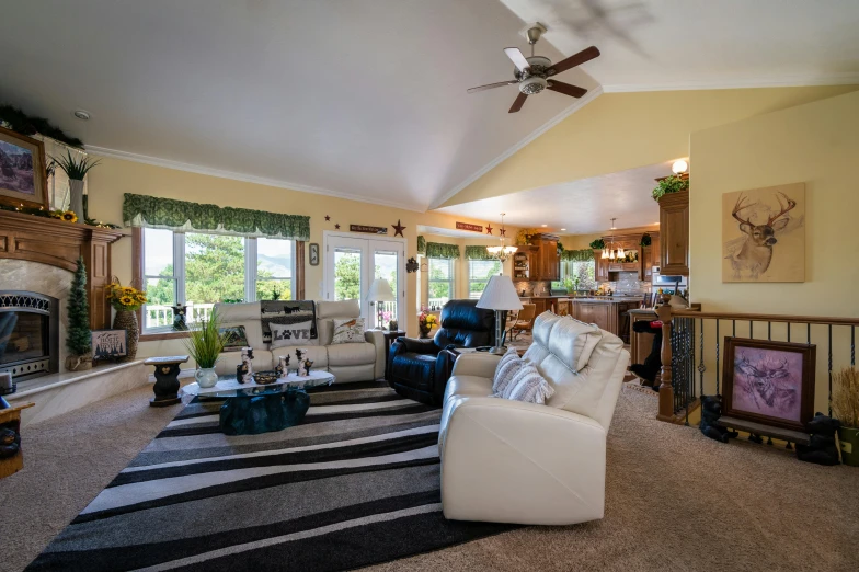 living room with two sets of furniture and a striped rug