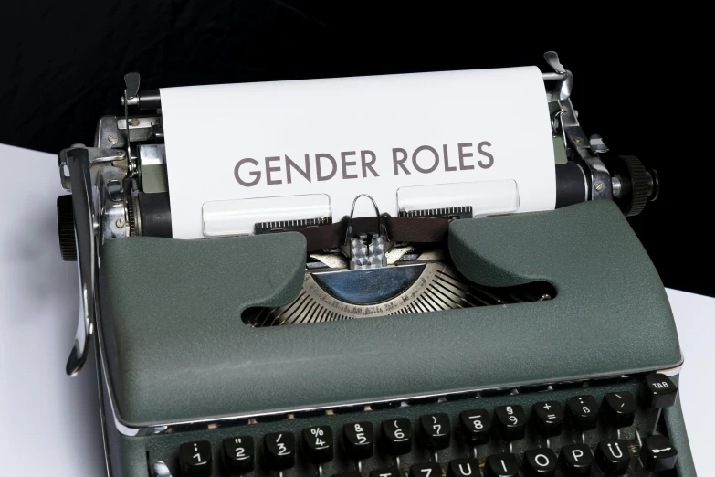 a typewriter with an old fashioned paper that says gender roles