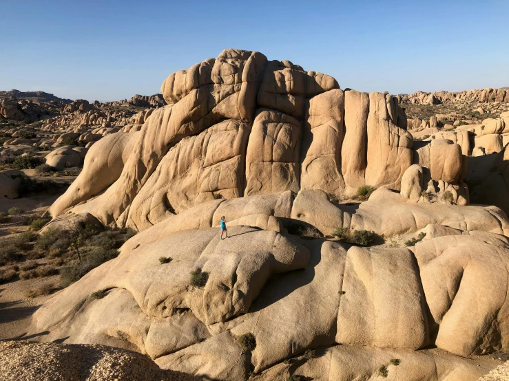 a mountain with many rocks in it and a blue sky above