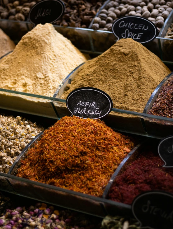 the spices are displayed for sale on the table