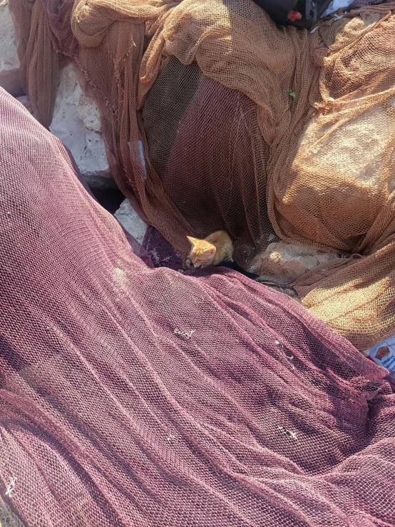 a pile of pink and brown objects with a hat