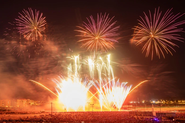 several fireworks exploding from the sky over a beach