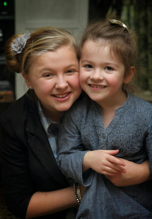 two little girls who are hugging each other