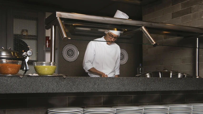 a man is cooking in the kitchen in a restaurant