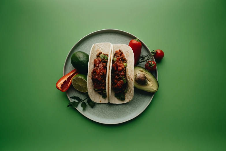 a plate filled with two chili covered sandwiches