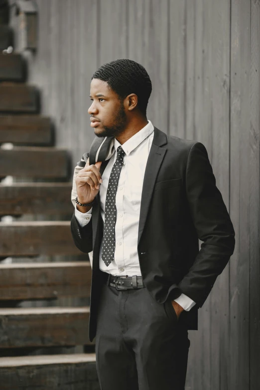 a man is looking down at his tie