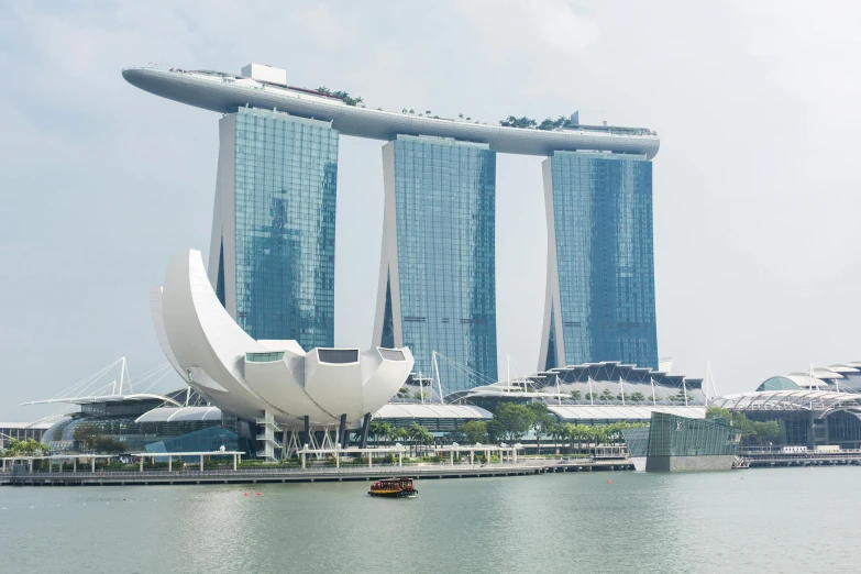 a white building on the water near large buildings