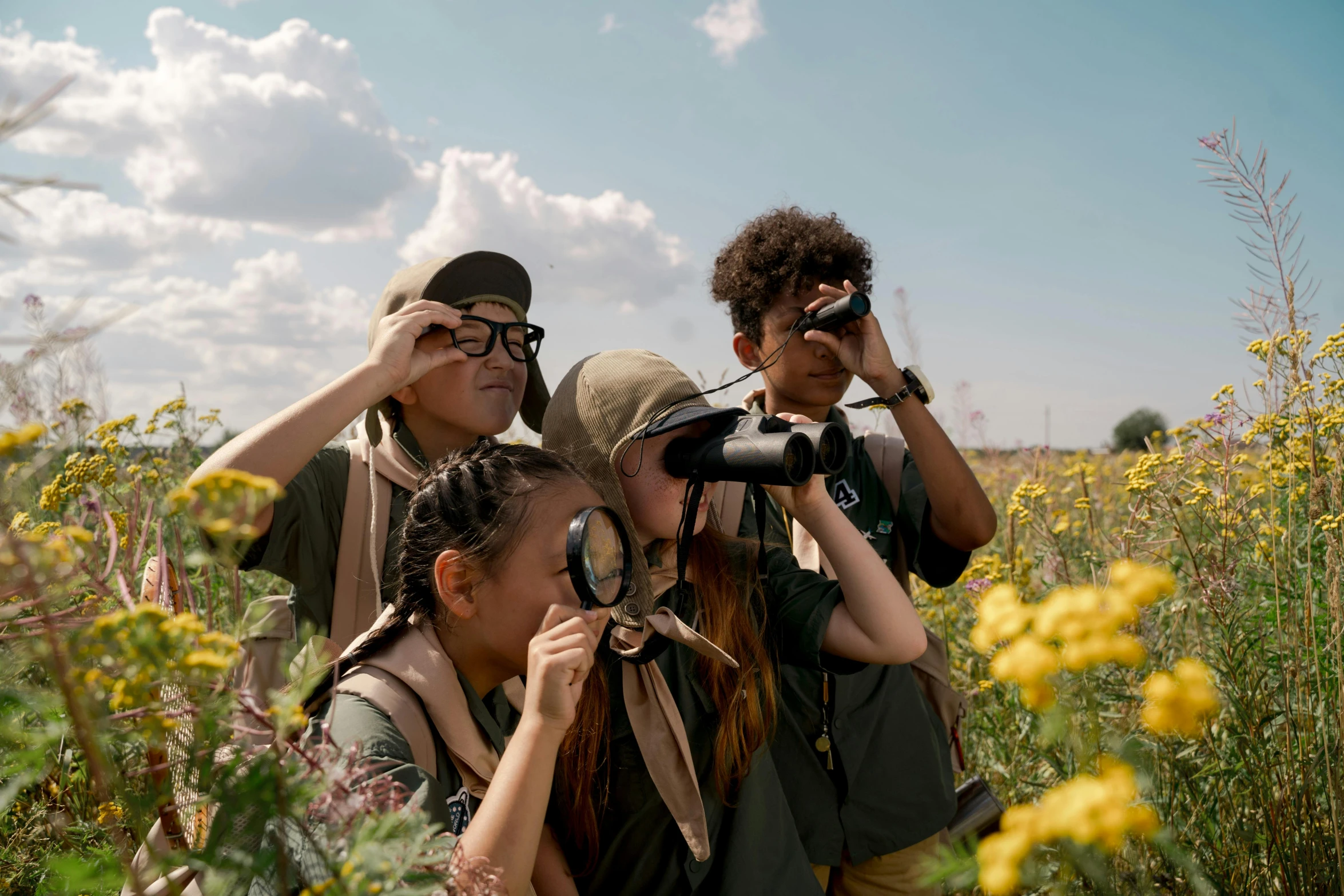 a group of people with cameras standing in a field