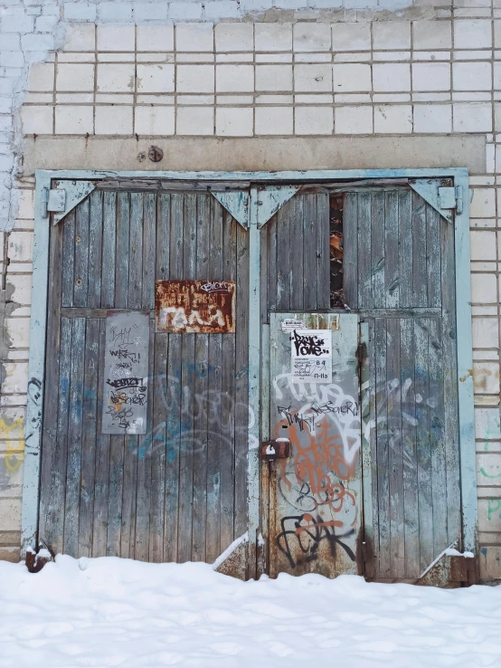 the doorway to an old building has graffiti on it