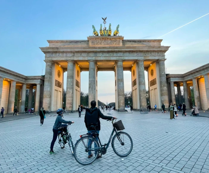 a group of men with bicycles in front of the famous monument