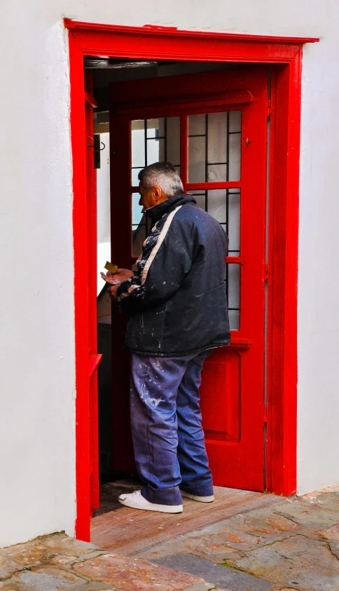 an older man at the red phone booth