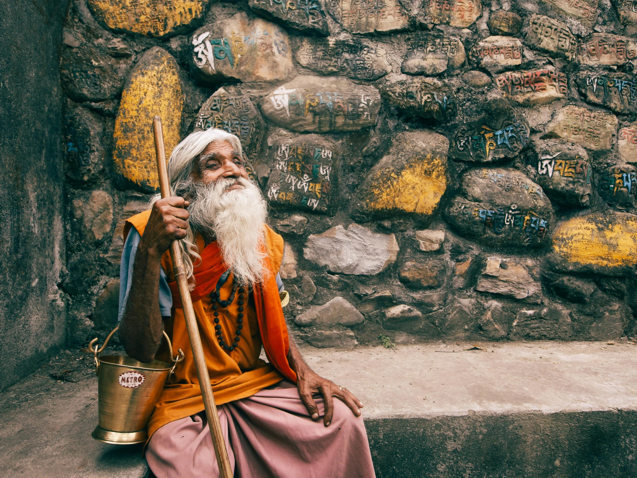 a man sitting down on the sidewalk