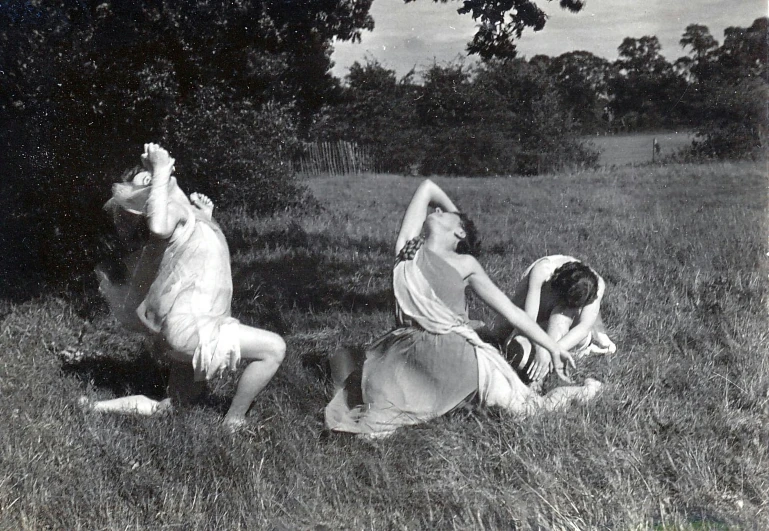 three people dressed in old fashion posing outside in a field