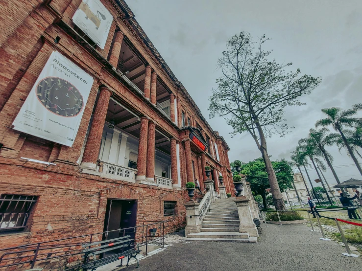 a brick building on a street corner and a metal fence and gate