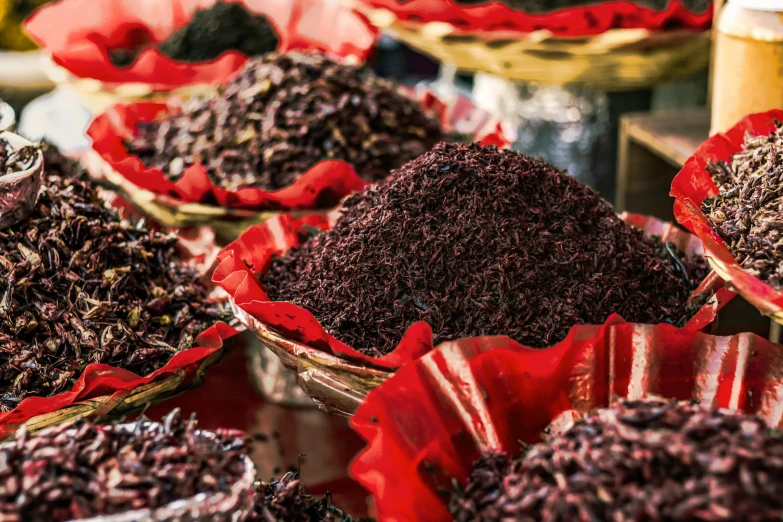 many baskets filled with red items at a market