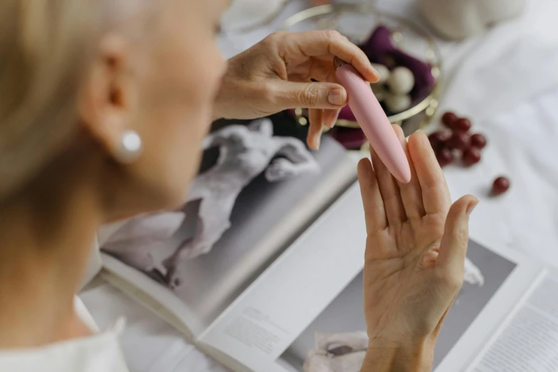 woman reading a book, putting an object in her hands