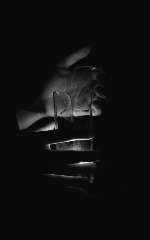 a hand and a small object that appears to be sitting on the table