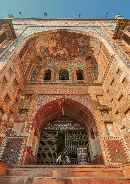 a building with ornate architecture has an ornate gate on the side