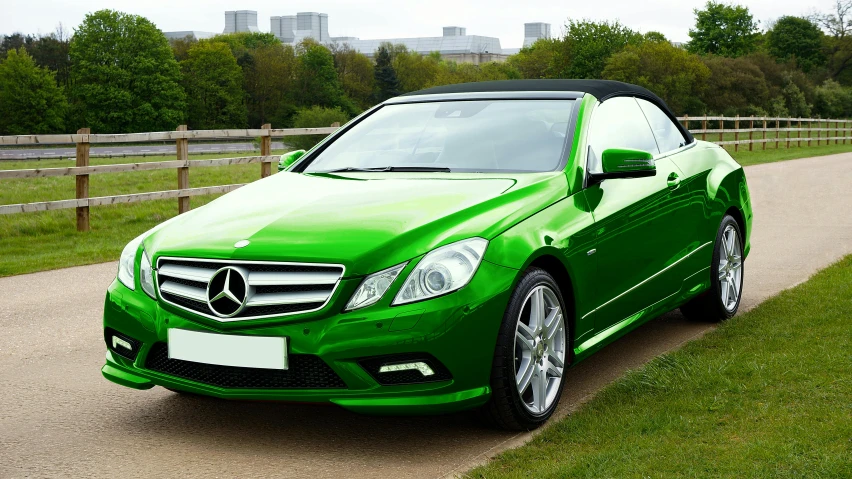 green mercedes benz benz c class convertible on the road