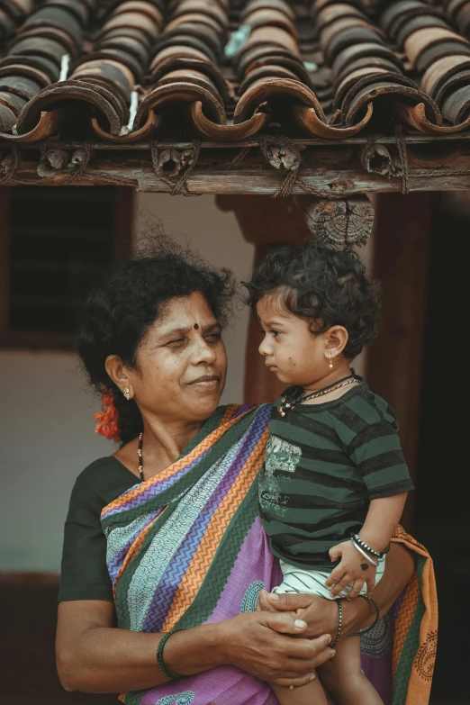 a woman in an indian village holds her child