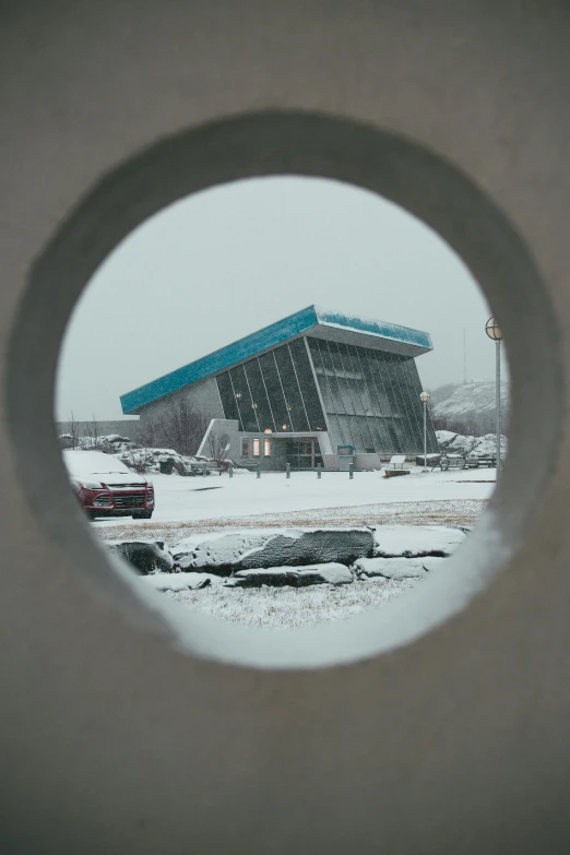 a very big building near some snow covered ground