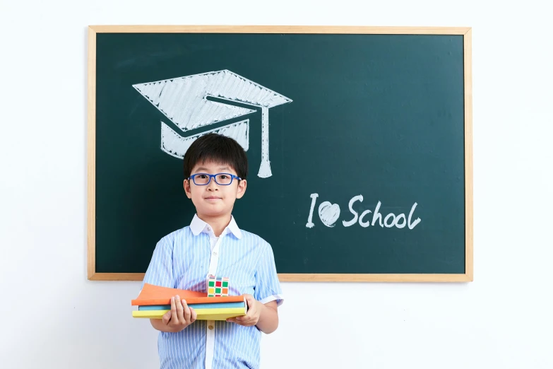 a little boy in glasses holding an object