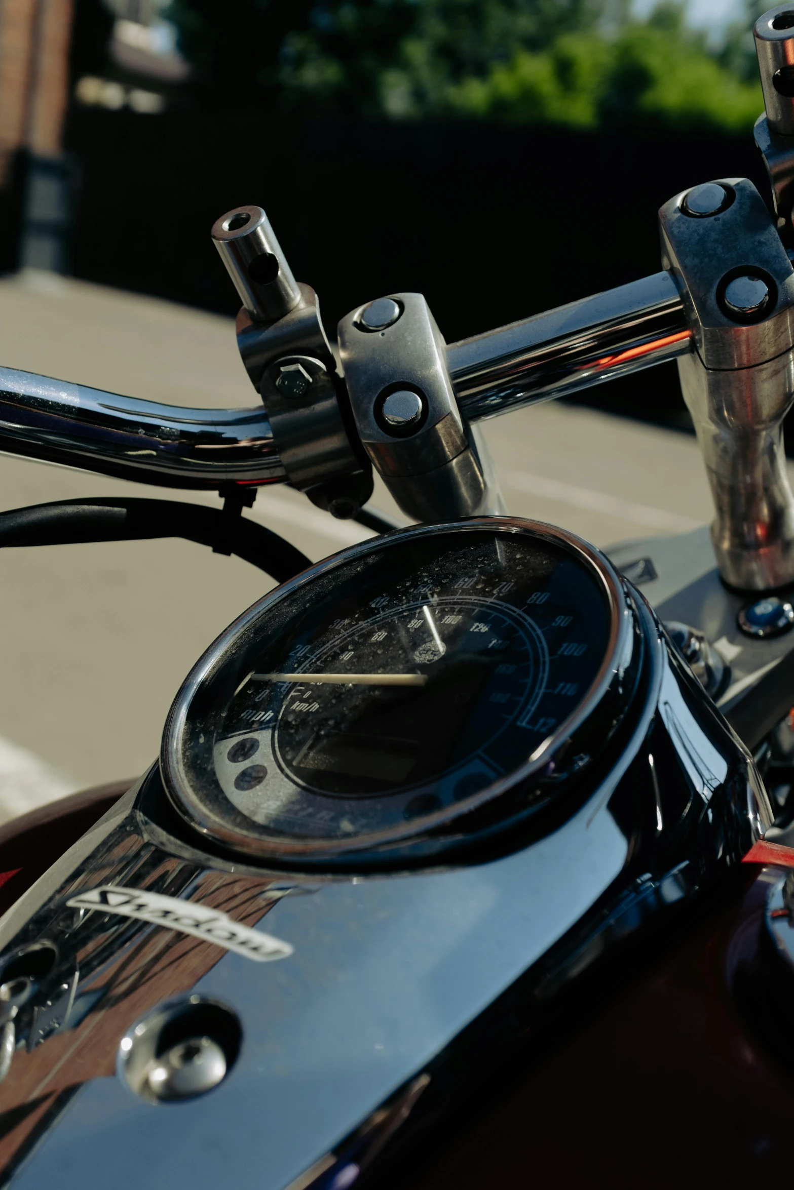 the handlebars and gauges on a motor bike