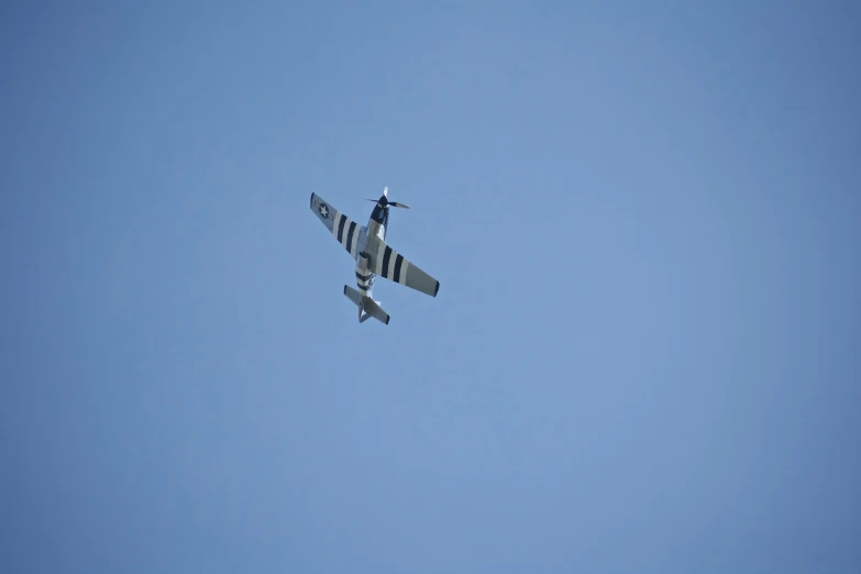 a jet fighter flying against a clear blue sky