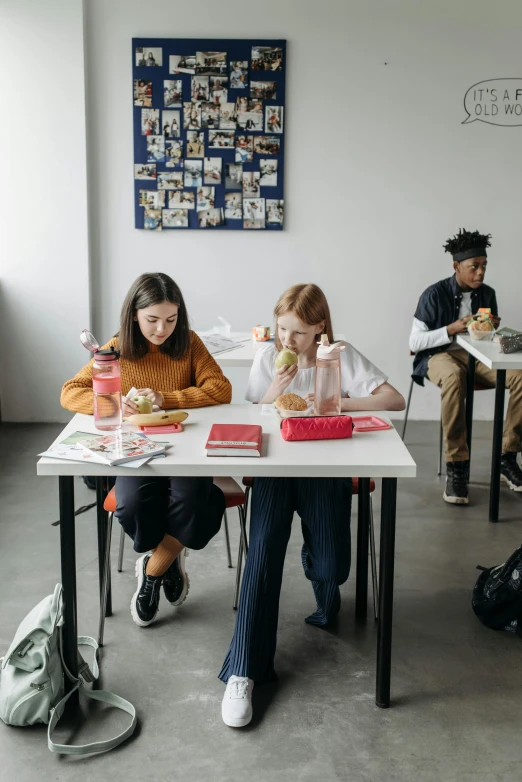 three children at a table with beaks