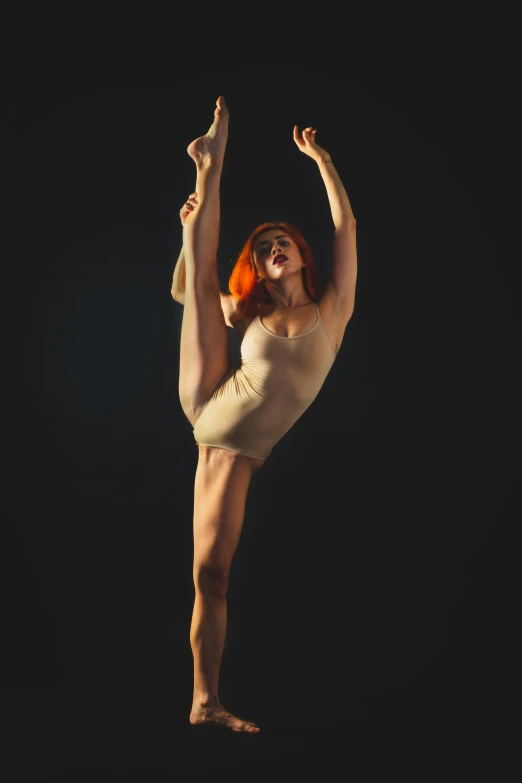 a women in white bodysuit doing dance against black background